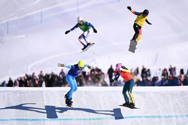 Italy's Michela Moioli (bottom L), France's Julia Nirani-Pereira (top L), Australia's Josie Baff (bottom R) and Germany's Jana Fischer (top R) compete the snowboard mixed team cross semi final 2 during the Milano Cortina 2026 Winter Olympic Games at Livigno Snow Park, in Livigno (Valtellina), on February 15, 2026. (Photo by Kirill KUDRYAVTSEV / AFP)