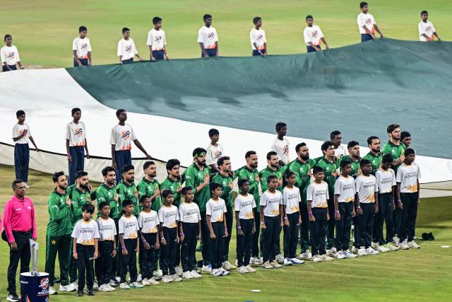 Pakistan's team players stand for the national anthem before the start of the 2026 ICC Men's T20 Cricket World Cup group stage match between India and Pakistan at the R Premadasa Stadium in Colombo on February 15, 2026. (Photo by Ishara S. KODIKARA / AFP)