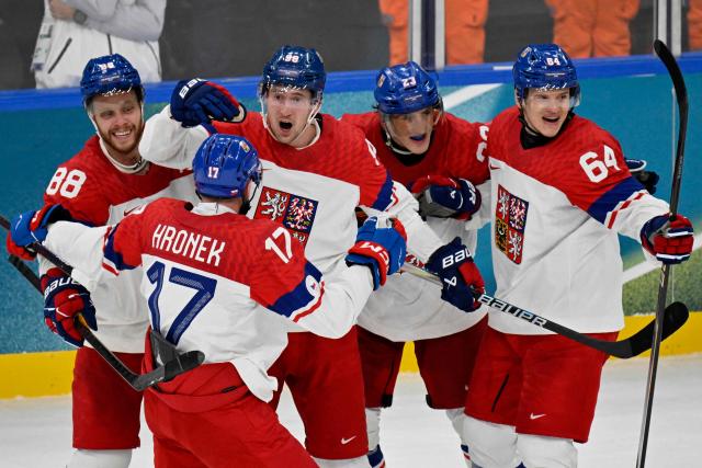 Czech Republic's #98 Martin Necas (C) celebrates with teammates after scoring his team's third goal during the men's preliminary round Group A Ice Hockey match between Switzerland and Czech Republic at the Milano Santagiulia Ice Hockey Arena during the Milano Cortina 2026 Winter Olympic Games in Milan, on February 15, 2026. (Photo by Alexander NEMENOV / AFP)