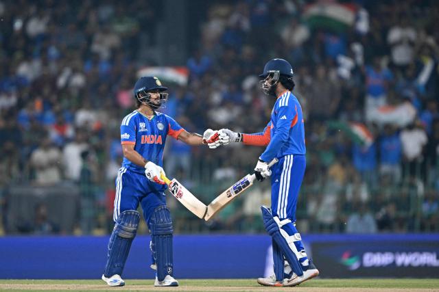 India's Ishan Kishan (L) and Tilak Varma bump their fists during the 2026 ICC Men's T20 Cricket World Cup group stage match between India and Pakistan at the R Premadasa Stadium in Colombo on February 15, 2026. (Photo by Ishara S.KODIKARA / AFP)