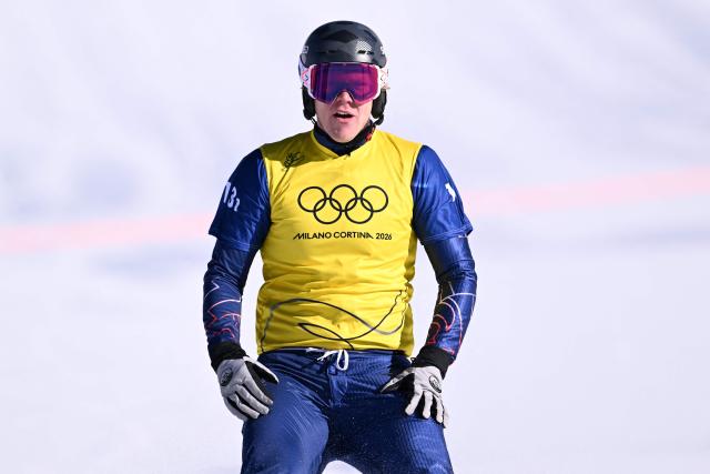 Britain's Huw Nightingale reacts after competing in the snowboard mixed team cross final during the Milano Cortina 2026 Winter Olympic Games at Livigno Snow Park, in Livigno (Valtellina), on February 15, 2026. (Photo by Kirill KUDRYAVTSEV / AFP)