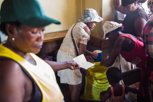 Residents queue during a food distribution at a public primary school used as a shelter for people affected by the passage of tropical cyclone Gezani during the night of February 10 to 11, in Toamasina on February 15, 2026. (Photo by RIJASOLO / AFP)