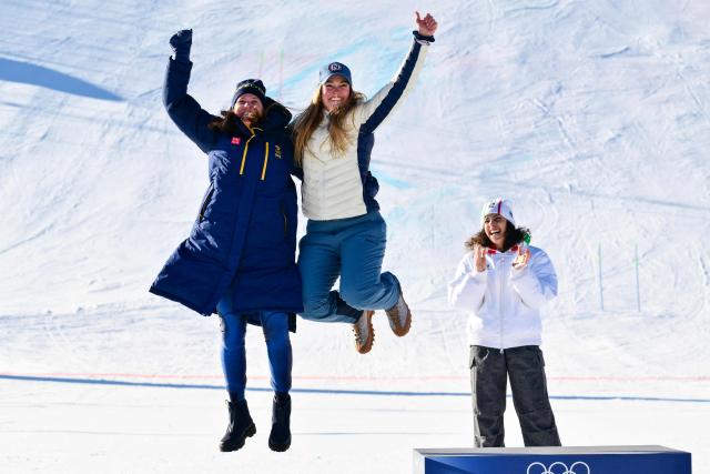 Gold medallist Italy's Federica Brignone (R) and tied silver medallists Norway's Thea Louise Stjernesund (C) and Sweden's Sara Hector (L) celebrate  on the podium of the women's giant slalom event during the Milano Cortina 2026 Winter Olympic Games at the Tofane Alpine Skiing Centre in Cortina d’Ampezzo on February 15, 2026. (Photo by Stefano RELLANDINI / AFP)