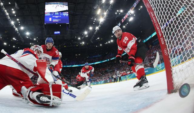 Switzerland's #28 Timo Meier (R) scores his team's second goal against Czech Republic's #01 Lukas Dostal during men's preliminary round Group A Ice Hockey match between Switzerland and Czech Republic at the Milano Santagiulia Ice Hockey Arena during the Milano Cortina 2026 Winter Olympic Games in Milan, on February 15, 2026. (Photo by POOL / AFP)