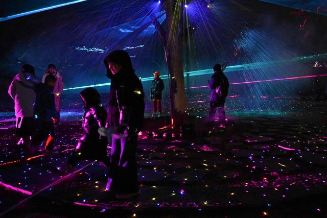 People visit a park in Beijing on February 15, 2026 ahead of the Lunar New Year of the Horse. (Photo by Pedro PARDO / AFP)