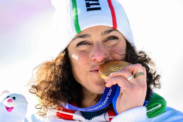 Gold medallist Italy's Federica Brignone poses  on the podium of the women's giant slalom event during the Milano Cortina 2026 Winter Olympic Games at the Tofane Alpine Skiing Centre in Cortina d’Ampezzo on February 15, 2026. (Photo by Stefano RELLANDINI / AFP)