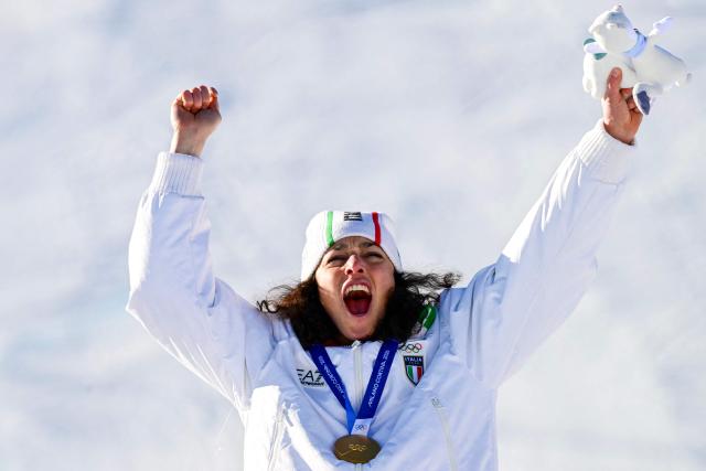 Gold medallist Italy's Federica Brignone celebrates on the podium of the women's giant slalom event during the Milano Cortina 2026 Winter Olympic Games at the Tofane Alpine Skiing Centre in Cortina d’Ampezzo on February 15, 2026. (Photo by Stefano RELLANDINI / AFP)