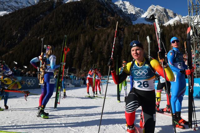 Belgium's Maya Cloetens (2nd R) reacts after crossing the finish line during the women's biathlon 10km pursuit event during the Milano Cortina 2026 Winter Olympic Games at the Anterselva Biathlon Arena (Sudtirol Arena) in Anterselva (Val Pusteria) on February 15, 2026. (Photo by Franck FIFE / AFP)