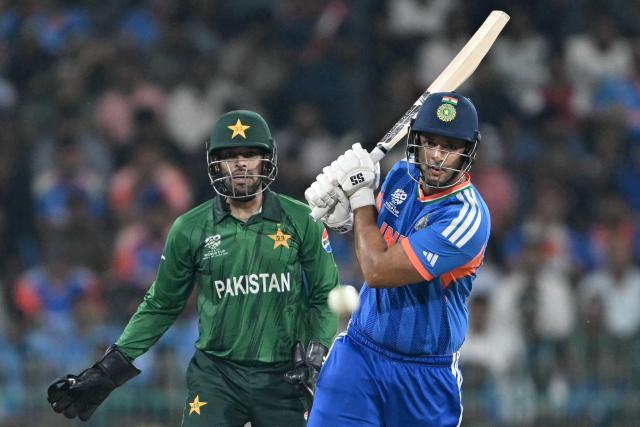 India's Shivam Dube (R) plays a shot as Pakistan's wicketkeeper Usman Khan watches during the 2026 ICC Men's T20 Cricket World Cup group stage match between India and Pakistan at the R Premadasa Stadium in Colombo on February 15, 2026. (Photo by Ishara S.KODIKARA / AFP)
