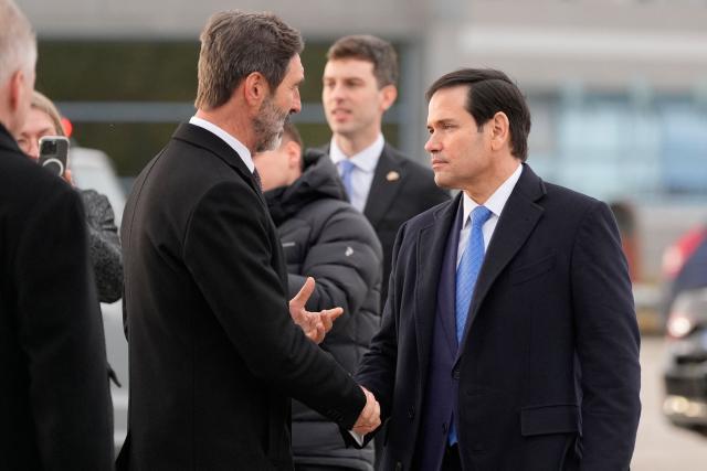 US Secretary of State Marco Rubio (R) shakes hands with Slovak Foreign Minister Juraj Blanar before departing from Bratislava Airport in Bratislava, Slovakia, on February 15, 2026. (Photo by Alex Brandon / POOL / AFP)