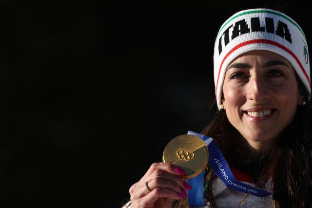 Gold medallist Italy's Lisa Vittozzi poses on the podium of the women's biathlon 10km pursuit event during the Milano Cortina 2026 Winter Olympic Games at the Anterselva Biathlon Arena (Sudtirol Arena) in Anterselva (Val Pusteria) on February 15, 2026. (Photo by FRANCK FIFE / AFP)