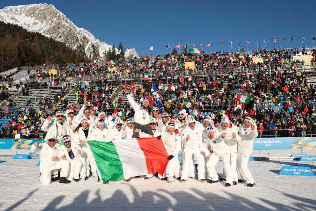 Gold medallist Italy's Lisa Vittozzi (above) poses with her teammates after the victory ceremony of the women's biathlon 10km pursuit event during the Milano Cortina 2026 Winter Olympic Games at the Anterselva Biathlon Arena (Sudtirol Arena) in Anterselva (Val Pusteria) on February 15, 2026. (Photo by Odd ANDERSEN / AFP)