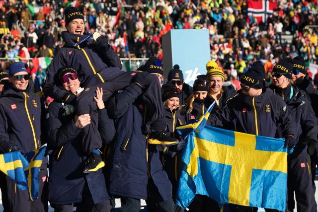 Gold medallist Sweden's Martin Ponsiluoma (above) poses with his teammates following the victory ceremony of the men's biathlon 12,5km pursuit event during the Milano Cortina 2026 Winter Olympic Games at the Anterselva Biathlon Arena (Sudtirol Arena) in Anterselva (Val Pusteria) on February 15, 2026. (Photo by Odd ANDERSEN / AFP)