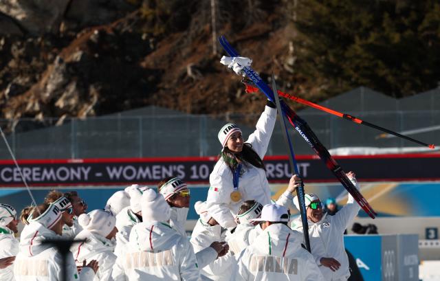 Gold medallist Italy's Lisa Vittozzi (above) celebrates with her teammates following the victory ceremony of the women's biathlon 10km pursuit event during the Milano Cortina 2026 Winter Olympic Games at the Anterselva Biathlon Arena (Sudtirol Arena) in Anterselva (Val Pusteria) on February 15, 2026. (Photo by FRANCK FIFE / AFP)