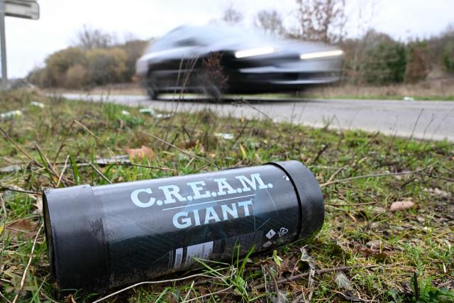 A nitrous oxyde canister, used as laughing gas, is seen on the ground on the side of a road in Volmerange-les-Mines, eastern France on February 15, 2026. (Photo by Jean-Christophe VERHAEGEN / AFP)