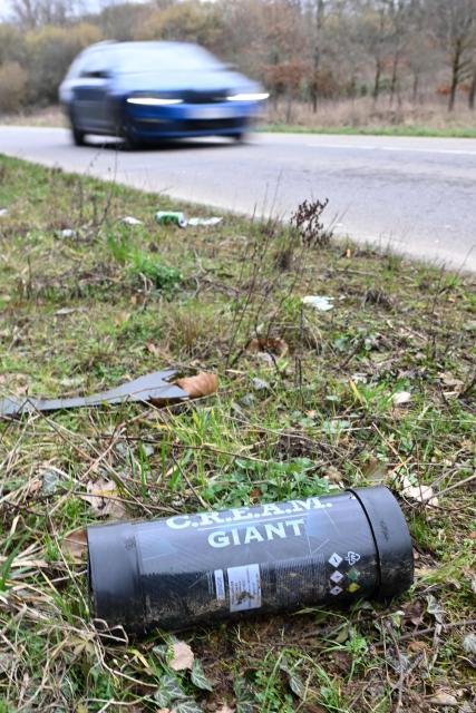 A nitrous oxyde canister, used as laughing gas, is seen on the ground on the side of a road in Volmerange-les-Mines, eastern France on February 15, 2026. (Photo by Jean-Christophe VERHAEGEN / AFP)