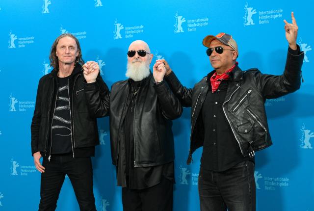 (From L) Canadian director Sam Dunn, Judas Priest singer and actor Rob Halford and former Rage Against the Machine guitarist and director Tom Morello pose during a photo call for the film 'The Ballad of Judas Priest' presented in Berlinale Special Gala at the 76th Berlinale, Europe's first major film festival of the year, in Berlin on February 15, 2026. (Photo by RALF HIRSCHBERGER / AFP)