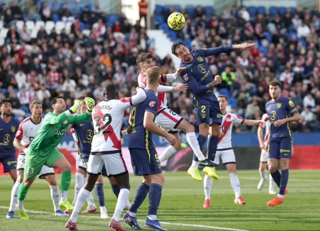 Rayo Vallecano's Romanian defender #02 Andrei Ratiu (up,R) heads the ball during the Spanish league football match between Rayo Vallecano de Madrid and Club Atletico de Madrid at Butarque Stadium in Leganes, south of Madrid on February 15, 2026. (Photo by Pierre-Philippe MARCOU / AFP)