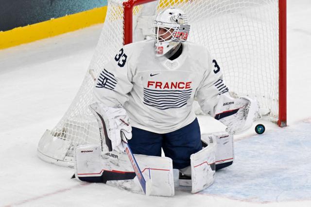 France's #33 Julian Junca reacts after Canada's third goal during the men's preliminary round Group A Ice Hockey match between Canada and France at the Milano Santagiulia Ice Hockey Arena during the Milano Cortina 2026 Winter Olympic Games in Milan, on February 15, 2026. (Photo by Alexander NEMENOV / AFP)