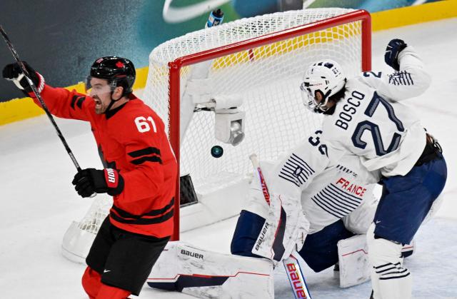 Canada's #61 Mark Stone celebrates scoring his team's third goal against France's #33 Julian Junca (C hidden) during the men's preliminary round Group A Ice Hockey match between Canada and France at the Milano Santagiulia Ice Hockey Arena during the Milano Cortina 2026 Winter Olympic Games in Milan, on February 15, 2026. (Photo by Alexander NEMENOV / AFP)