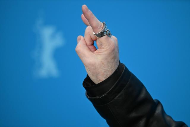 Judas Priest singer and actor Rob Halford gestures during a photo call for the film 'The Ballad of Judas Priest' presented in Berlinale Special Gala at the 76th Berlinale, Europe's first major film festival of the year, in Berlin on February 15, 2026. (Photo by RALF HIRSCHBERGER / AFP)