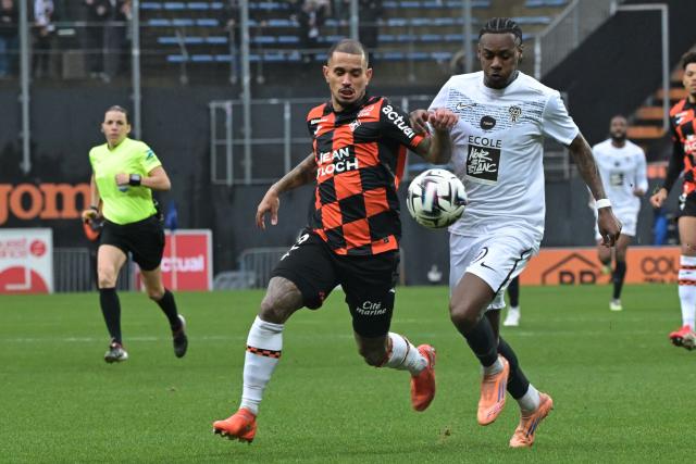Lorient’s Brazilian defender #02 Igor Silva (2ndR) fights for the ball with Angers’ French defender #27 Lilian Raolisoa during the French L1 football match between FC Lorient and SCO Angers at the Stade du Moustoir in Lorient, western France, on February 15, 2026. (Photo by Damien Meyer / AFP)