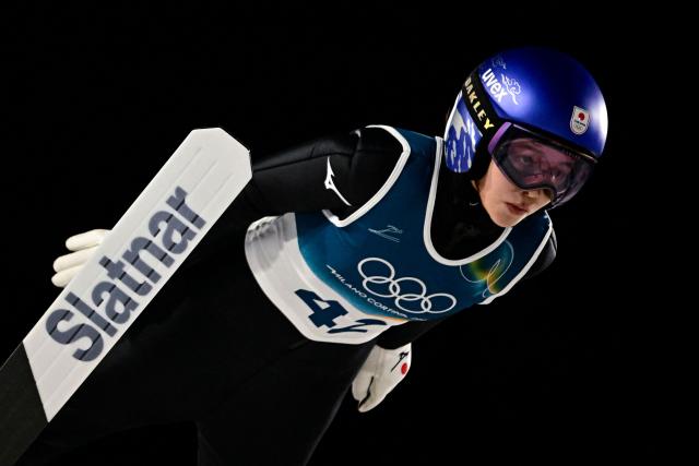 Japan's Sara Takanashi jumps during the trial round of the women's large hill individual ski jumping of the Milano Cortina 2026 Winter Olympic Games at Predazzo Ski Jumping Stadium in Predazzo (Val di Fiemme), on February 15, 2026. (Photo by Tobias SCHWARZ / AFP)
