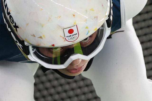 Japan's Nozomi Maruyama prepares to jump during the trial round of the women's large hill individual ski jumping of the Milano Cortina 2026 Winter Olympic Games at Predazzo Ski Jumping Stadium in Predazzo (Val di Fiemme), on February 15, 2026. (Photo by Anne-Christine POUJOULAT / AFP)