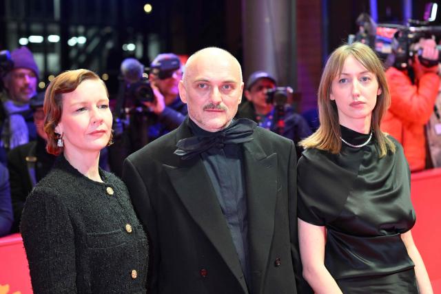 German actress Sandra Hueller, Austrian Director Markus Schleinzer and German actress Caro Braun pose on the red carpet prior the premiere for the film "Rose" presented in competition at the 76th Berlinale, Europe's first major film festival of the year, in Berlin on February 15, 2026. (Photo by RALF HIRSCHBERGER / AFP)