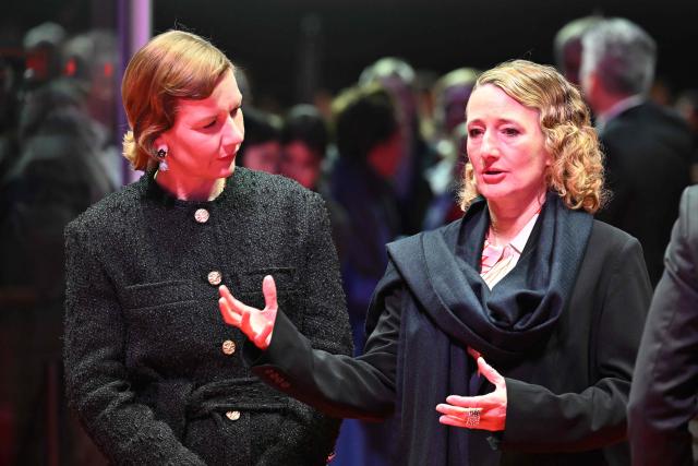 German actress Sandra Hueller and Berlinale director Tricia Tuttle talk together on the red carpet prior the premiere for the film "Rose" presented in competition at the 76th Berlinale, Europe's first major film festival of the year, in Berlin on February 15, 2026. (Photo by RALF HIRSCHBERGER / AFP)