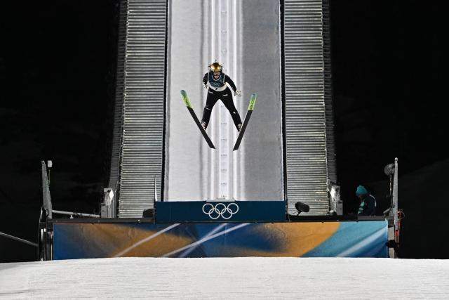 France's Emma Chervet jumps during the 1st round of the women's large hill individual ski jumping of the Milano Cortina 2026 Winter Olympic Games at Predazzo Ski Jumping Stadium in Predazzo (Val di Fiemme), on February 15, 2026. (Photo by Javier SORIANO / AFP)