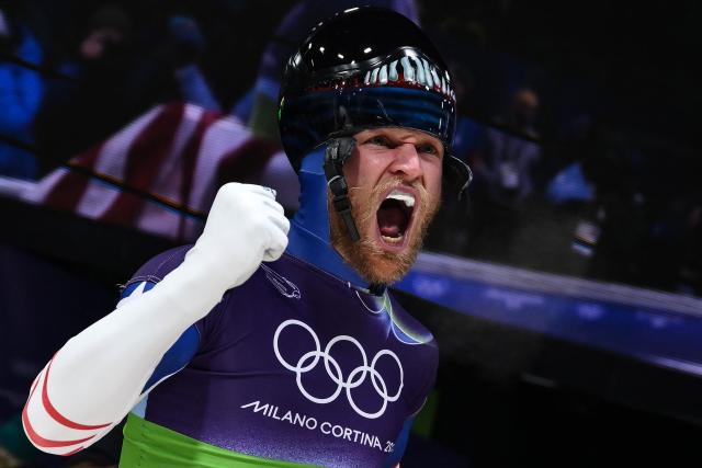 USA's Austin Florian celebrates after competing in the skeleton mixed team event at Cortina Sliding Centre during the Milano Cortina 2026 Winter Olympic Games in Cortina d'Ampezzo on February 15, 2026. (Photo by Marco BERTORELLO / AFP)