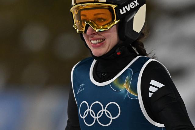 Germany's Juliane Seyfarth reacts after jumping during the 1st round of the women's large hill individual ski jumping of the Milano Cortina 2026 Winter Olympic Games at Predazzo Ski Jumping Stadium in Predazzo (Val di Fiemme), on February 15, 2026. (Photo by Javier SORIANO / AFP)
