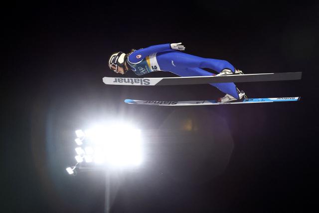 Canada's Abigail Strate jumps during the final round of the women's large hill individual ski jumping of the Milano Cortina 2026 Winter Olympic Games at Predazzo Ski Jumping Stadium in Predazzo (Val di Fiemme), on February 15, 2026. (Photo by Anne-Christine POUJOULAT / AFP)