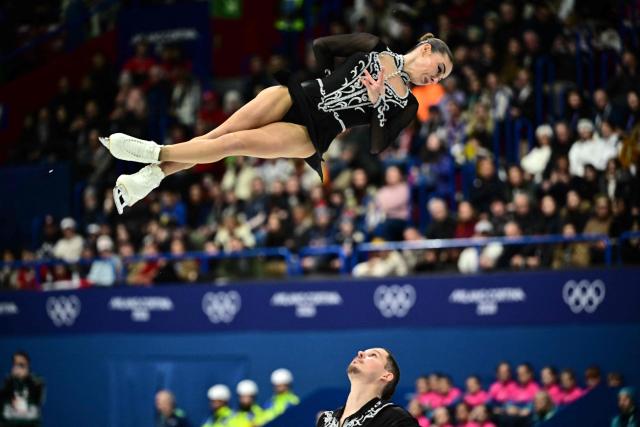 Armenia's Nikita Rakhmanin and Armenia's Karina Akopova compete in the figure skating pair skating short program during the Milano Cortina 2026 Winter Olympic Games at Milano Ice Skating Arena in Milan on February 15, 2026. (Photo by JULIEN DE ROSA / AFP)