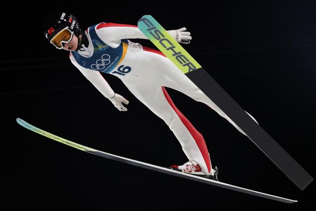 China's Qi Liu jumps during the final round of the women's large hill individual ski jumping of the Milano Cortina 2026 Winter Olympic Games at Predazzo Ski Jumping Stadium in Predazzo (Val di Fiemme), on February 15, 2026. (Photo by Anne-Christine POUJOULAT / AFP)