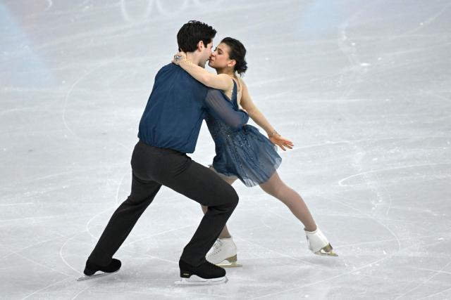 Australia's Anastasiia Golubeva and Australia's Hektor Giotopoulos Moore compete in the figure skating pair skating short program during the Milano Cortina 2026 Winter Olympic Games at Milano Ice Skating Arena in Milan on February 15, 2026. (Photo by WANG Zhao / AFP)