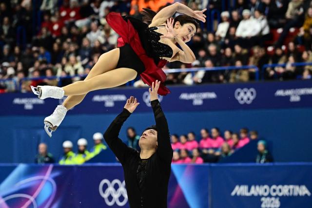 China's Han Cong and China's Sui Wenjing compete in the figure skating pair skating short program during the Milano Cortina 2026 Winter Olympic Games at Milano Ice Skating Arena in Milan on February 15, 2026. (Photo by JULIEN DE ROSA / AFP)