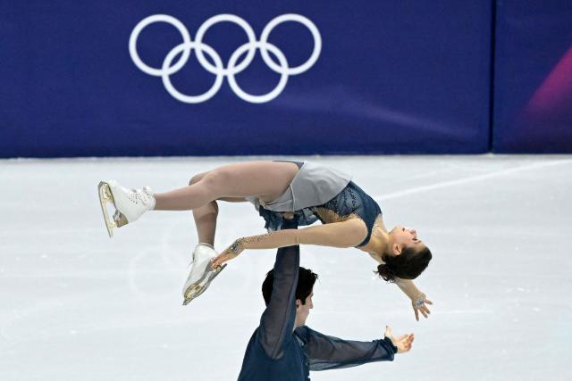Australia's Anastasiia Golubeva and Australia's Hektor Giotopoulos Moore compete in the figure skating pair skating short program during the Milano Cortina 2026 Winter Olympic Games at Milano Ice Skating Arena in Milan on February 15, 2026. (Photo by WANG Zhao / AFP)