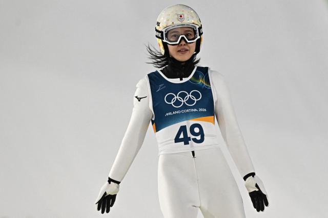 Japan's Nozomi Maruyama reacts after jumping during the final round of the women's large hill individual ski jumping of the Milano Cortina 2026 Winter Olympic Games at Predazzo Ski Jumping Stadium in Predazzo (Val di Fiemme), on February 15, 2026. (Photo by Javier SORIANO / AFP)