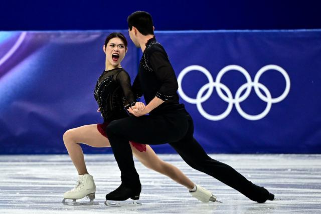 USA's Emily Chan and USA's Spencer Akira Howe compete in the figure skating pair skating short program during the Milano Cortina 2026 Winter Olympic Games at Milano Ice Skating Arena in Milan on February 15, 2026. (Photo by JULIEN DE ROSA / AFP)