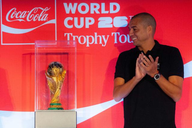 French former football player David Trezeguet looks at the original FIFA World Cup trophy during its tour in Bogota, Colombia, on February 15, 2026. (Photo by Luis ACOSTA / AFP)