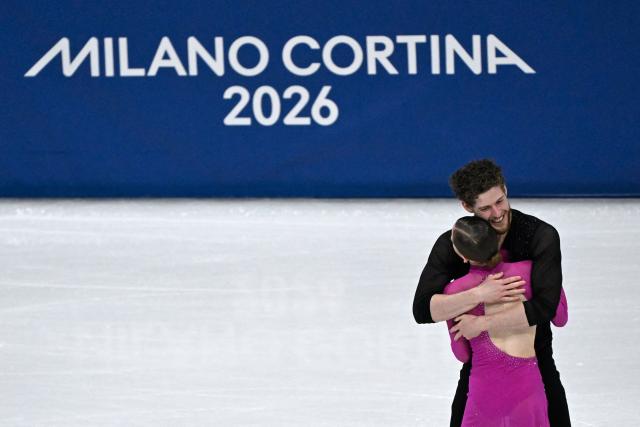 Poland's Ioulia Chtchetinina and Poland's Michal Wozniak compete in the figure skating pair skating short program during the Milano Cortina 2026 Winter Olympic Games at Milano Ice Skating Arena in Milan on February 15, 2026. (Photo by WANG Zhao / AFP)