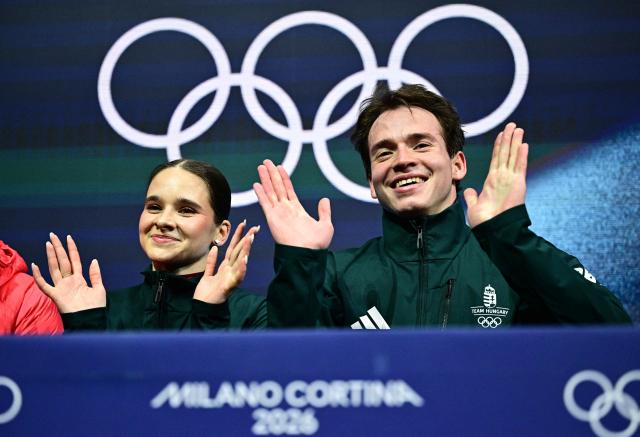 Hungary's Maria Pavlova and Hungary's Aleksei Sviatchenko react in the kiss and cry area after competing in the figure skating pair skating short program during the Milano Cortina 2026 Winter Olympic Games at Milano Ice Skating Arena in Milan on February 15, 2026. (Photo by JULIEN DE ROSA / AFP)