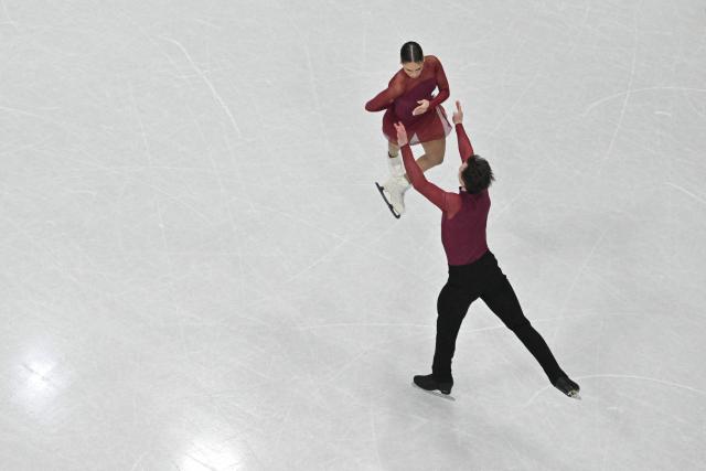 Hungary's Maria Pavlova and Hungary's Aleksei Sviatchenko compete in the figure skating pair skating short program during the Milano Cortina 2026 Winter Olympic Games at Milano Ice Skating Arena in Milan on February 15, 2026. (Photo by Antonin THUILLIER / AFP)