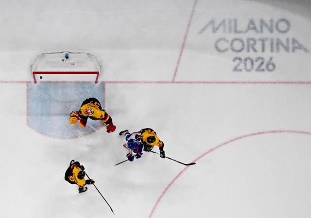 USA's #09 Jack Eichel (2R) vies for the puck with Germany's #37 Maximilian Franzreb (L) and team mates as the puck lands in the net during the men's preliminary round Group C Ice Hockey match between USA and Germany at the Milano Santagiulia Ice Hockey Arena during the Milano Cortina 2026 Winter Olympic Games in Milan, on February 15, 2026. (Photo by Alexander NEMENOV / AFP)