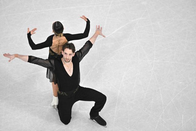 Italy's Sara Conti and Italy's Niccolo Macii compete in the figure skating pair skating short program during the Milano Cortina 2026 Winter Olympic Games at Milano Ice Skating Arena in Milan on February 15, 2026. (Photo by Antonin THUILLIER / AFP)