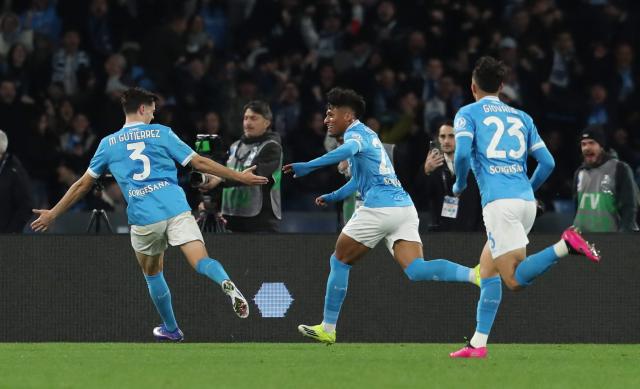 Napoli's Brazilian midfielder #27 Alisson Santos (C) celebrates with teammates after scoring Napoli's second goal during the Italian Serie A football match between SSC Napoli and AS Roma at the Diego Armando Maradona Stadium in Naples on February 15, 2026. (Photo by CARLO HERMANN / AFP)