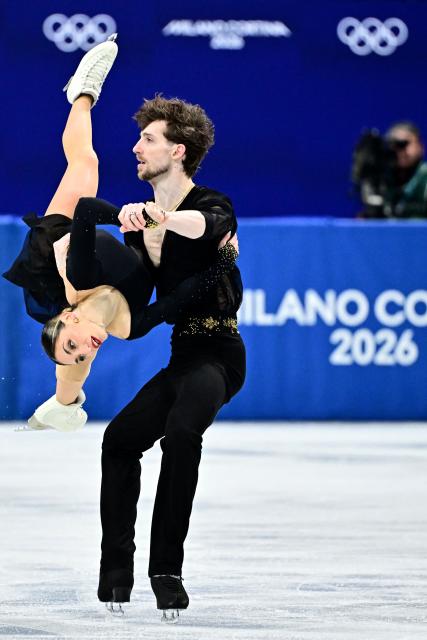 Italy's Sara Conti and Italy's Niccolo Macii compete in the figure skating pair skating short program during the Milano Cortina 2026 Winter Olympic Games at Milano Ice Skating Arena in Milan on February 15, 2026. (Photo by JULIEN DE ROSA / AFP)
