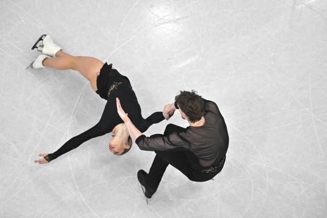 Italy's Sara Conti and Italy's Niccolo Macii compete in the figure skating pair skating short program during the Milano Cortina 2026 Winter Olympic Games at Milano Ice Skating Arena in Milan on February 15, 2026. (Photo by Antonin THUILLIER / AFP)